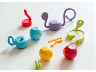 Collection of small fishing accessories including bobbers shaped like music notes and guitar pick weights